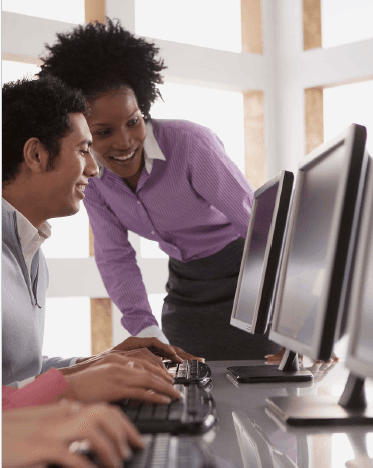 Man and lady looking at computer screens